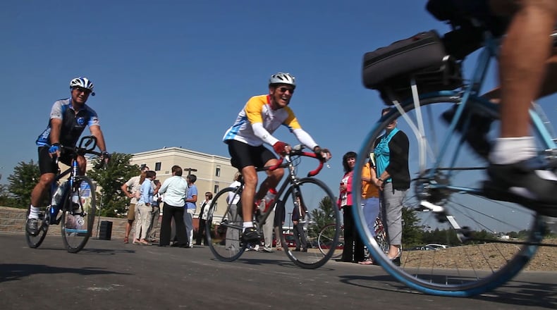 Members of the Dayton Bicycle Club roll away from the Courtyard Marriot Hotel after the official opening of a new 0.7-mile bike path that connects to the region's 300-mile network of connected, paved trails at the Stewart Street Bridge.  The Miami Valley Regional Planning Commission is updating the regional bikeways plan. And it wants your opinion.