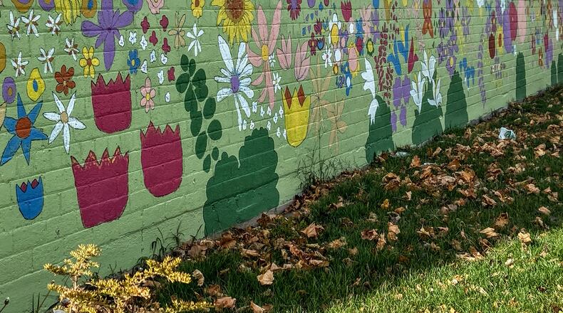 Forest Wortham of Washington Twp. took this photo on Nov. 19 of a mural on the side of a building at 425 Xenia Ave., Dayton. He says, “A hidden mural of bright, lively spring and summer flowers contrasts with dead leaves in the grass.”