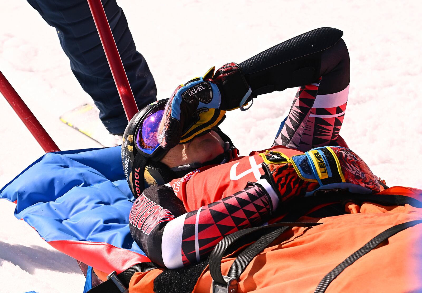 Italy's Federica Brignone is carried away on a toboga after she broke multiple bones in her left leg during a giant slalom crash at the Italian championships in the Lusia ski area, in Val di Fassa, Italy, Thursday, April 3, 2025. (AP Photo/Elvis Piazzi)