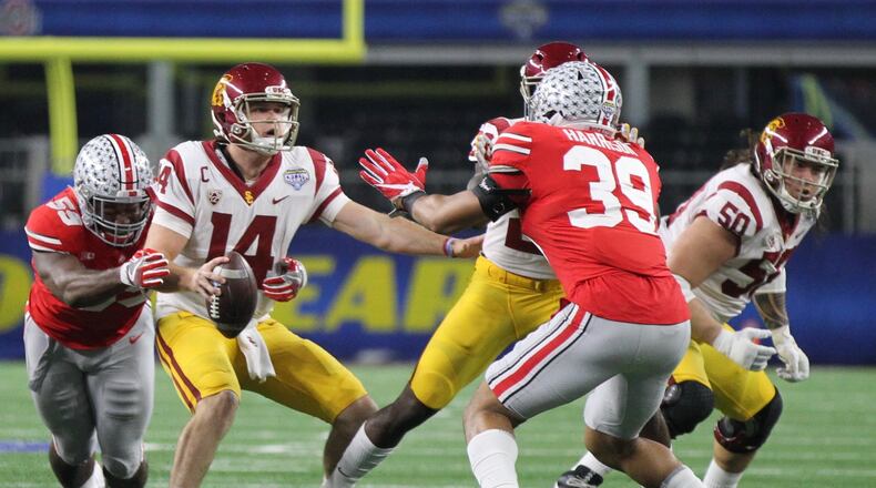 Ohio States Tyquan Lewis pressures Southern Californias Sam Darnold on Friday, Dec. 29, 2017, at AT&T Stadium in Arlington, Texas. David Jablonski/Staff