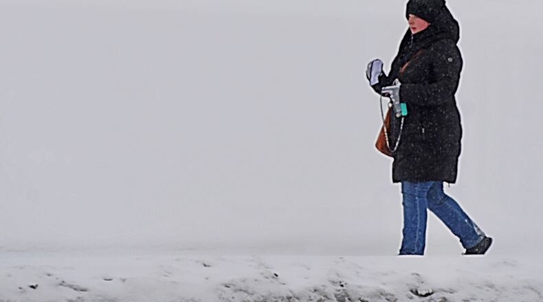 Taking a walk on Paramount Place near Wright State University on a cold and snowy Monday, February 15, 2021. MARSHALL GORBY/STAFF
