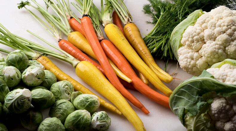 Fresh vegetables for three side dishes: Smashed carrots with feta and mint, brussels sprouts with smoky chorizo and sweet-and-sour cauliflower with golden raisins, in New York, Oct. 4, 2017. Add some new flavors to your side dishes this Thanksgiving. (Karsten Moran/The New York Times)