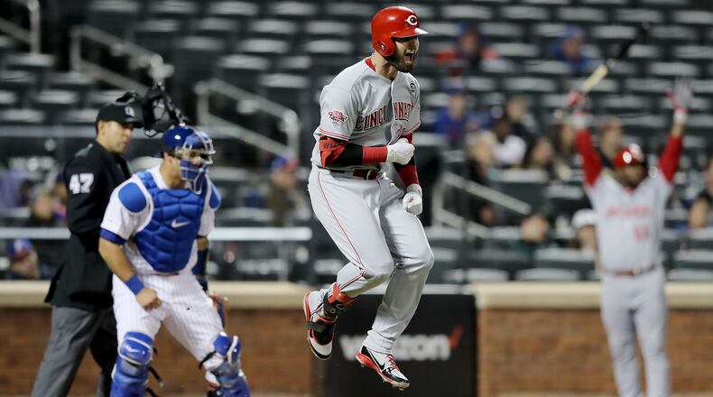 NEW YORK, NEW YORK - APRIL 29: Jesse Winker #33 of the Cincinnati Reds celebrates his game winning home run in the ninth inning as Wilson Ramos #40 of the New York Mets defends at Citi Field on April 29, 2019 in the Flushing neighborhood of the Queens borough of New York City.The Cincinnati Reds defeated the New York Mets 5-4. (Photo by Elsa/Getty Images)