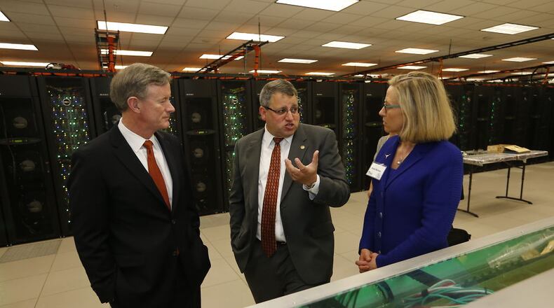 University of Texas System Chancellor Bill McRaven, left, gets a tour of the Texas Advanced Computing Center's new facilities on Thursday, June 2, 2016. Center is Dan Stanzione, executive director of the Texas Advanced Computing Center, and at right is ???