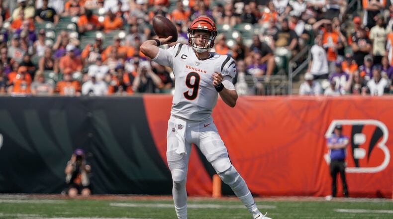 Cincinnati Bengals quarterback Joe Burrow (9) passes against the Minnesota Vikings during the second half of an NFL football game, Sunday, Sept. 12, 2021, in Cincinnati. (AP Photo/Jeff Dean)