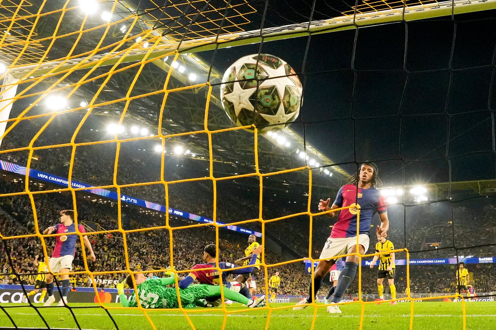 Dortmund's Serhou Guirassy scores his side's third goal during the Champions League quarterfinal second leg soccer match between Borussia Dortmund and FC Barcelona, in Dortmund, Germany, Tuesday, April 15, 2025. (AP Photo/Martin Meissner)
