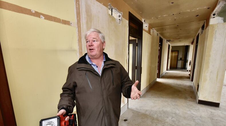 Developer Steve Coon walks through the Goetz Tower on the corner of Central Avenue and Main Street Friday, Oct. 26 in Middletown. After a water line break last winter, the Goetz Tower project is expected to get back on track to redevelop the office building into retail and apartment space. NICK GRAHAM/STAFF