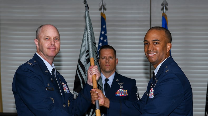 Space Force Col. Brett Swigert (left), Delta 7 commander, presents the 73rd Intelligence, Surveillance and Reconnaissance Squadron guidon to Space Force Lt. Col. Jeffrey Coverdale during a ceremony July 7 at Wright-Patterson Air Force Base. Coverdale replaces Lt. Col. Nathaniel Peace in the squadron’s first change of command since its activation into the Space Force in 2020. U.S. AIR FORCE PHOTO/MASTER SGT. PATRICK O’REILLY