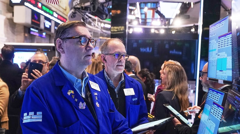 Specialist Patrick King, left, and trader Mark Puetzer work on the floor of the New York Stock Exchange, Wednesday, Jan. 28, 2026. (AP Photo/Richard Drew)