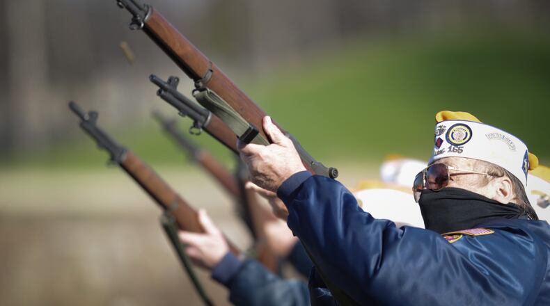 John Heinrich shoots during a funeral ceremony at Calvary Cemetery.  Heinrich is a part of the combined honor guard from the Kettering American Legion 598, Miamisburg American Legion 165 and the West Carrollton V.F.W. 3438. The groups are looking to  increase their ranks diminished by COVID-19 concerns and the course of time.
