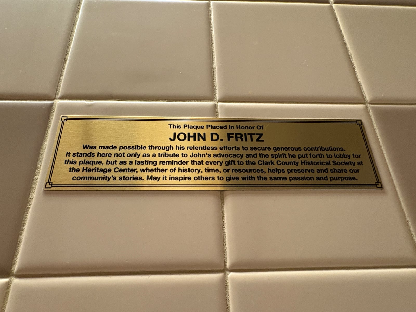 The tongue-in-cheek urinal plaque for volunteer John Fritz at The Heritage Center has a practical purpose: to raise support for the museum. CONTRIBUTED PHOTO.