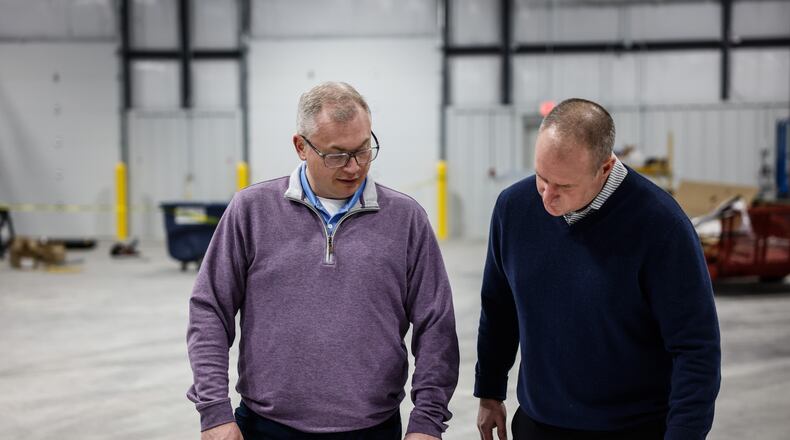 Bill Tolliver, Winsupply vice president for real estate services and in-house counsel, and Rob Ferguson, president of the Winsupply Local Company Group for Winsupply Inc., review plans for Winsupply's new Richard W. Schwartz Center for Innovation in Moraine. JIM NOELKER/STAFF