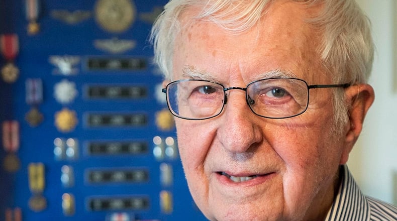 Retired Air Force Col. Jay Strayer is pictured in front of his military shadow box at home in Xenia on Nov. 23. Strayer was among the pilots who flew an HH-53 helicopter in the Son Tay prisoner-of-war rescue attempt during the Vietnam War in 1970. U.S. AIR FORCE PHOTO/WESLEY FARNSWORTH