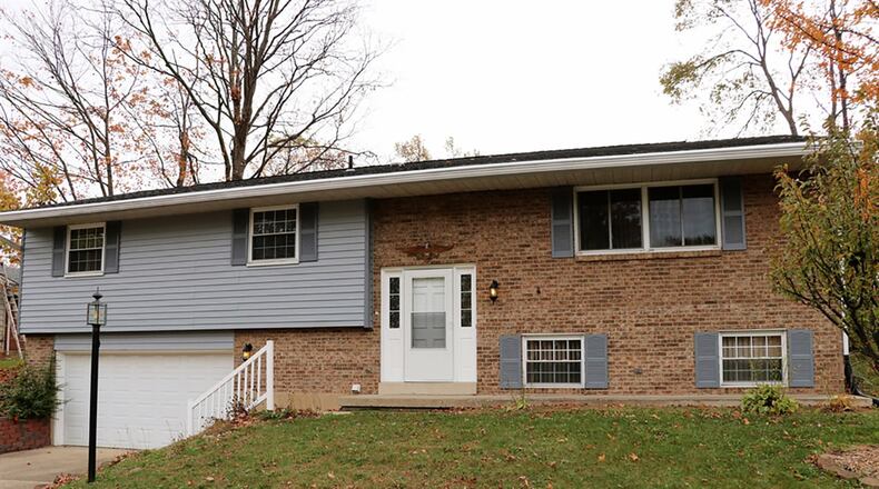 The aluminum-and-frame bi-level has about 2,260 sq. ft. of living space with 3 bedrooms. The exterior siding has been painted, and steps lead up from the concrete driveway at the 2-car garage to the formal entry. CONTRIBUTED PHOTOS BY KATHY TYLER