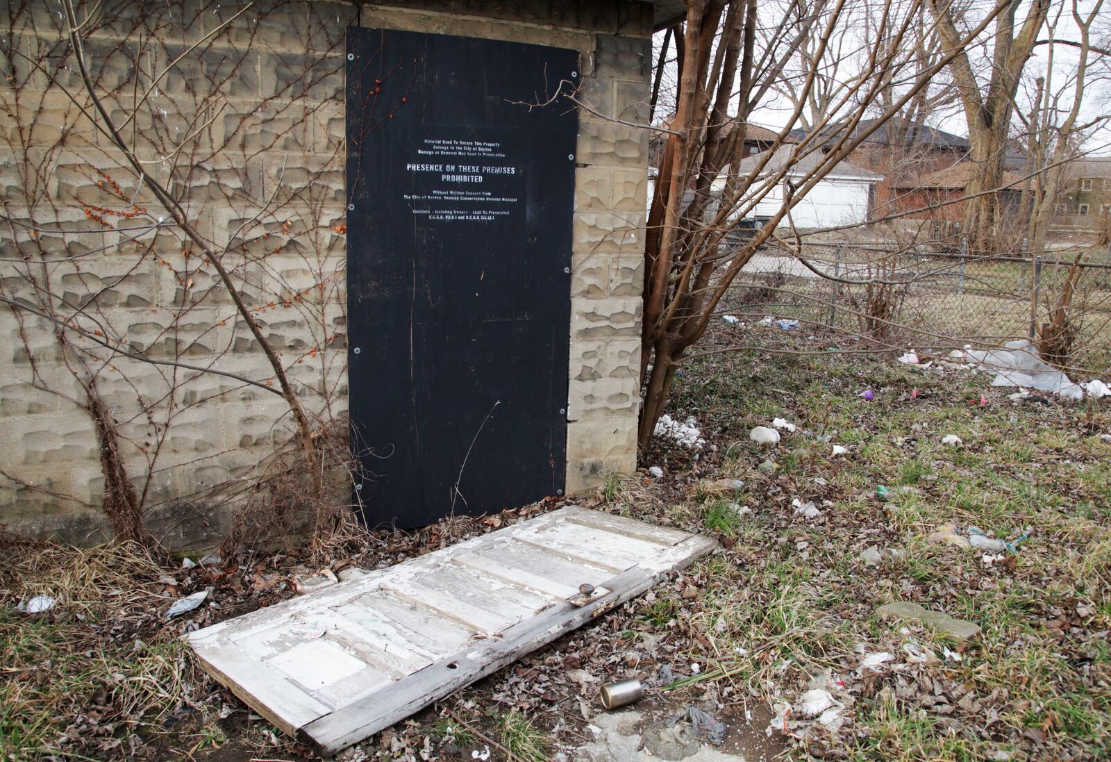 The body of Deanna Prendergast, 39, of Kettering was found on the ground under a door in the back yard near this detached garage of the duplex at 15-17 E. Hudson Ave. in Dayton on Sept. 15, 2017. STAFF Byron Stirsman