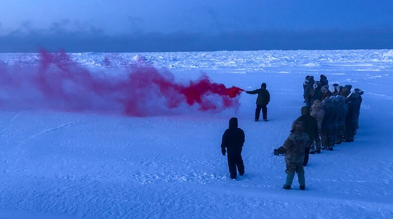Staff Sgt. Samuel Ley, a 66th Training Squadron, Detachment 1 survival, evasion, resistance and escape, or SERE, specialist, demonstrates how to use an MK-124 smoke and illumination signal on the Chukchi Sea Jan. 13. The MK-124 is a smoke and illumination flare used to signal search and rescue personnel in the event of an emergency or extraction situation. U.S. AIR FORCE PHOTO/MAJ. TYLER WILLIAMS