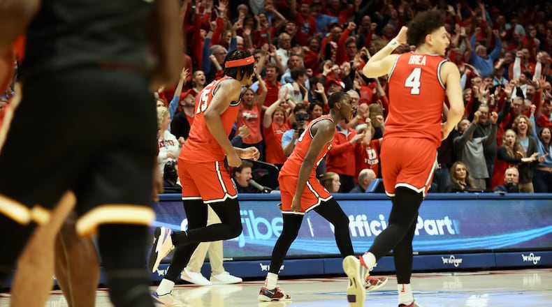 Dayton's Kobe Elvis celebrates after a go-ahead 3-pointer in the final minute of overtime against Virginia Commonwealth on Friday, March 8, 2024, at UD Arena. David Jablonski/Staff
