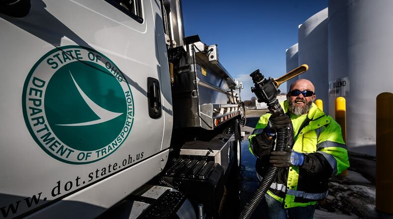 O.D.O.T. snowplow driver, Rob Gardner pumps an 80/20 brine mixture into his truck Tuesday December 20, 2022. O.D.O.T. road crews are readying their equipment for the winter weather heading to the Dayton area at the end of the week. JIM NOELKER/STAFF