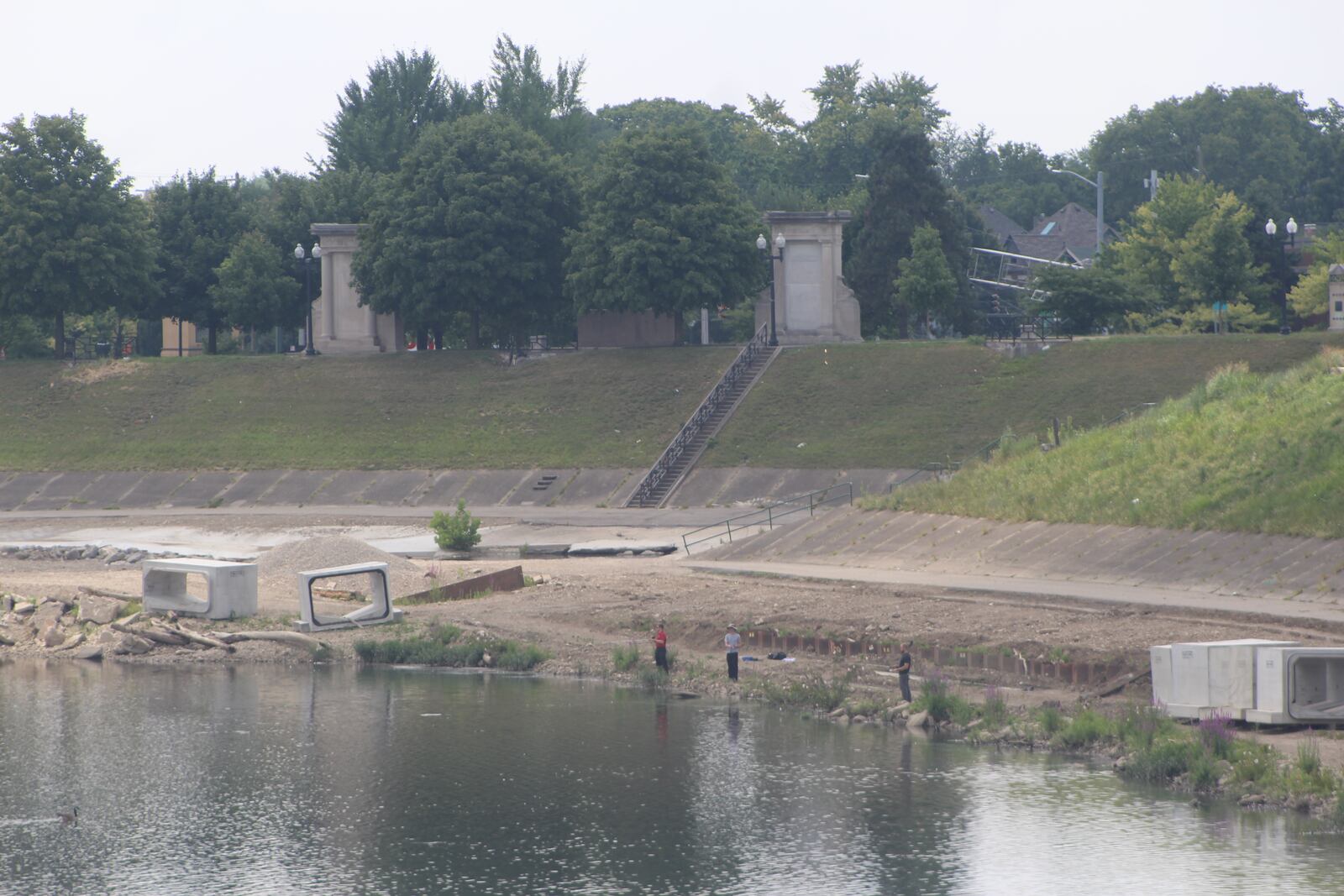 People fish along the banks of the Great Miami River, near the confluence of Wolf Creek. The Dayton Riverfront Plan includes a plan for the Suns project, which is a $150 million investment that would create a new pedestrian bridge, a new park and many new amenities along the riverbanks. CORNELIUS FROLIK / STAFF