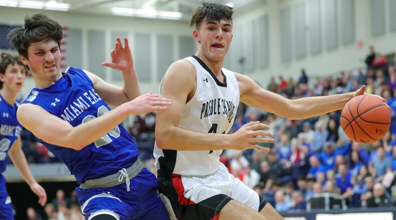 Preble Shawnee High School junior Logan Hawley collides with Miami East junior Devon Abshire during their Division III regional semifinal game on Wednesday night at Kettering's Trent Arena. The Arrows won 50-40. CONTRIBUTED PHOTO BY MICHAEL COOPER