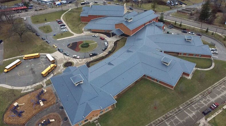 Dayton Public Schools has already resolved some construction problems from last decade’s building boom, such as a $900,000 settlement over defects in the roof construction of Wogaman School. TY GREENLEES / STAFF
