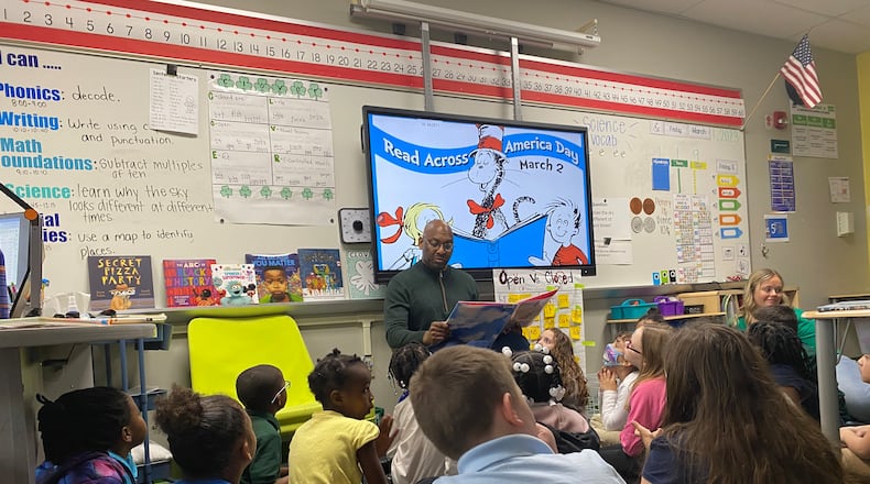 David Lawrence, Dayton Public Schools superintendent, reads to first-graders at Cleveland Elementary on Friday, March 1. The school was celebrating Read Across America Day on Saturday, March 2. Eileen McClory/ Staff