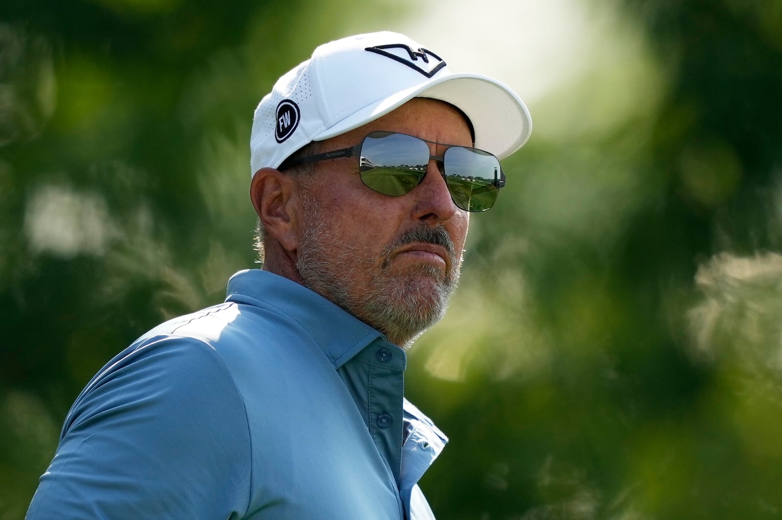 Phil Mickelson watches his tee shot on the 13th hole during the first round of the U.S. Open golf tournament at Oakmont Country Club Thursday, June 12, 2025, in Oakmont, Pa. (AP Photo/Carolyn Kaster)
