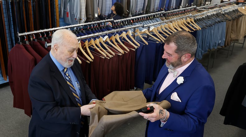 Edd Wimsatt, left, owner of Price Stores talks with store mgr. Joshua Singleton. The store is located at 553 Miamisburg Centerville Road in Centerville. MARSHALL GORBY\STAFF