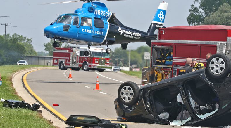 A Careflight helicopter lifts off with one of the victims of a fatal two car accident on Urbana Road just north of Ohio Route 334 Thursday, May 19, 2022. One passenger in the overturned car was killed and a person in the other car was taken by medic with non-life threatening injuries. BILL LACKEY/STAFF