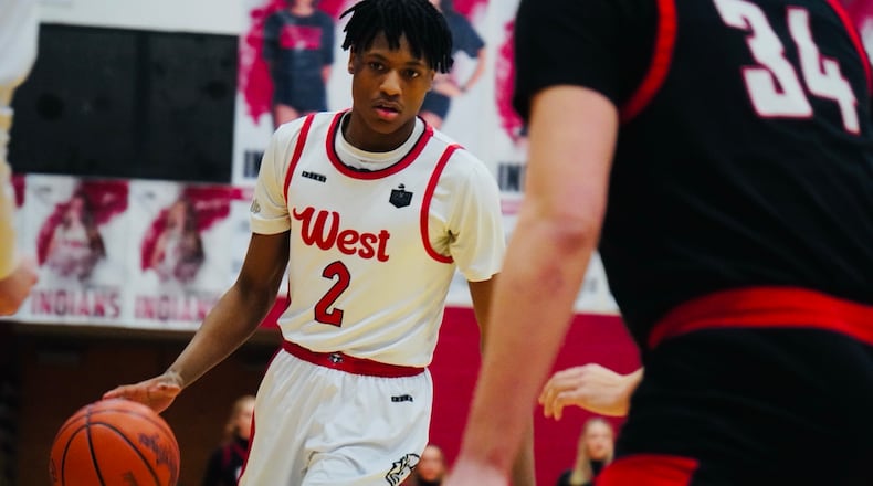 Lakota West guard Joshua Tyson (2) dribbles the ball while being guarded by Oak Hills forward Gabe Cox (34) on Friday night at Fairfield Arena. Chris Vogt/CONTRIBUTED