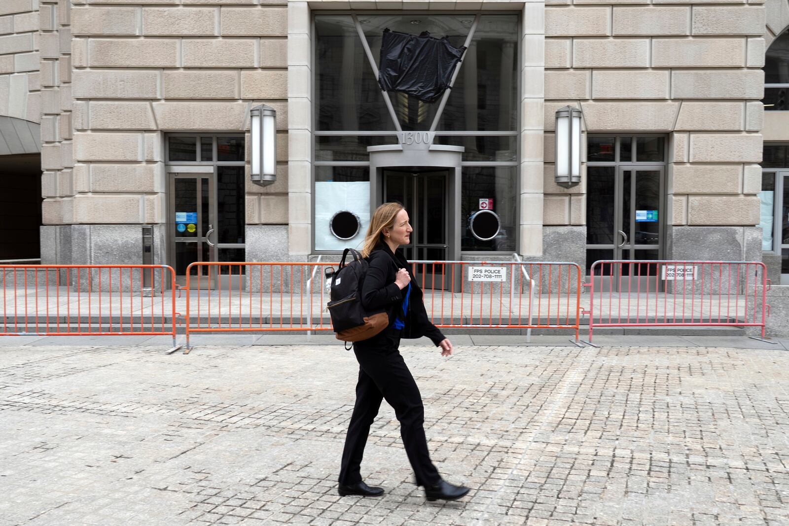 Laura Meissner walks in front of the United States Agency for International Development (USAID) headquarters, Wednesday, April 2, 2025, in Washington. (AP Photo/Rahmat Gul)