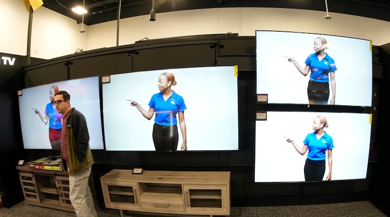 FILE - A customer turns away after looking at big-screen televisions on display in a Best Buy store, Nov. 21, 2023, in southeast Denver. (AP Photo/David Zalubowski, file)