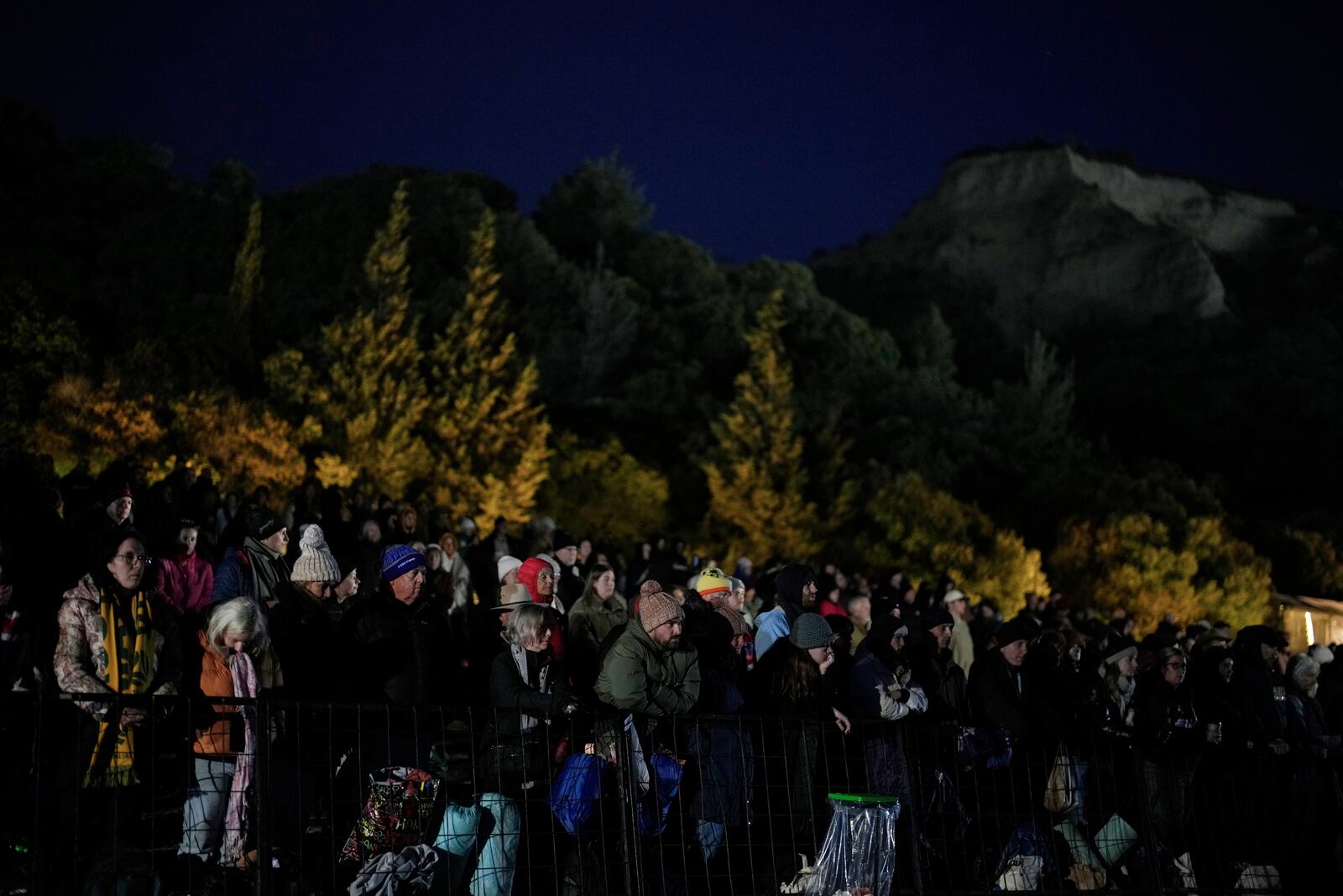 People attend the "Spirit of Place" ceremony and dawn memorial service at the Anzac Cove beach, the site of the April 25, 1915, World War I landing of the ANZAC (Australian and New Zealand Army Corps) on the Gallipoli peninsula, near Canakkale, Turkey, early Friday, April 25, 2025. (AP Photo/Emrah Gurel)