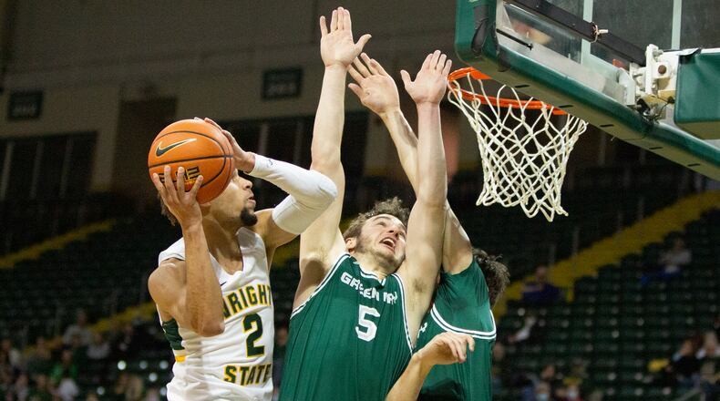 Wright State's Tanner Holden scores over Green Bay's Lucas Stieber (5) and Ryan Claflin during the first half of Saturday afternoon's game at the Nutter Center. Jeff Gilbert/CONTRIBUTED