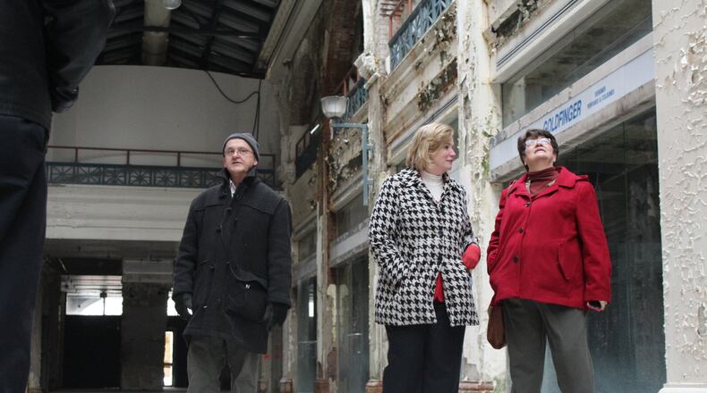 CityWide’s Urban Design Director John Gower, Dayton Mayor Nan Whaley and Rep. Peggy Lehner, R-Kettering, were part of a group that toured the Dayton Arcade on Wednesday. CORNELIUS FROLIK / STAFF