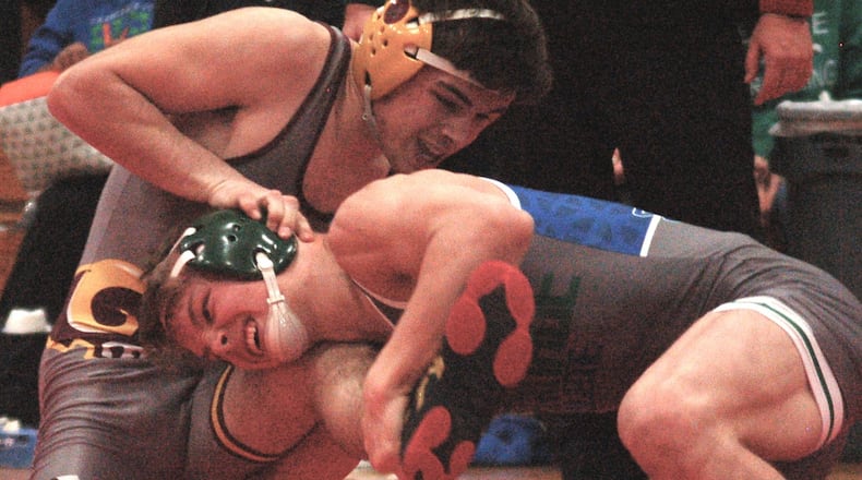 Chaminade Julienne’s Micah Marshall drives through to finish a takedown during his 11-4 win over Ross’ Sean Beltran in the Division II Region 15 finals Wednesday night at Chaminade Julienne High school. The Eagles fell to the Rams 41-30 in the dual. JOHN CUMMINGS / CONTRIBUTED