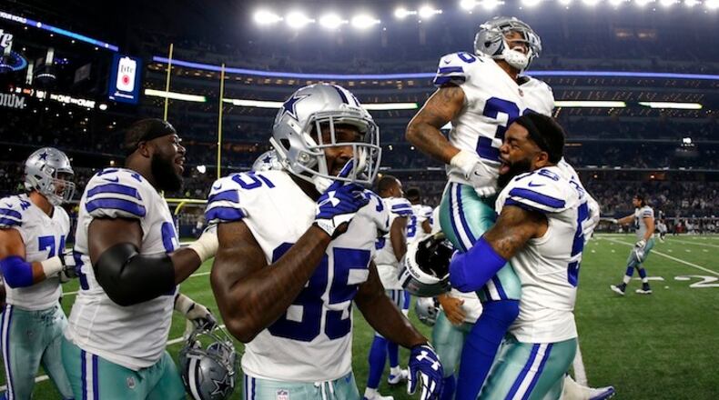 Dallas Cowboys wide receiver Noah Brown (85) celebrates as defensive end Damontre Moore, right, lifts safety Robert Blanton (36) after a defensive stop against the Oakland Raiders late in the second half of a preseason NFL football game, Saturday, Aug. 26, 2017, in Arlington, Texas. (AP Photo/Ron Jenkins)