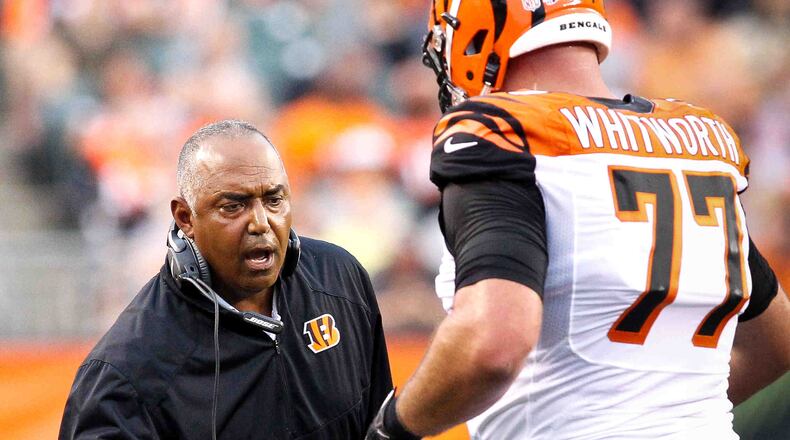 Cincinnati Bengals head coach Marvin Lewis high-fives offensive tackle Andrew Whitworth (77) during Saturday night's preseason game against the Jets Aug. 16, 2014, at Paul Brown Stadium in Cincinnati. NICK DAGGY / STAFF