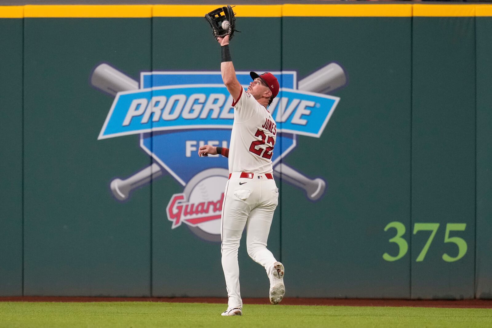 Cleveland Guardians' Nolan Jones (22) catches a fly ball hit for an out by Colorado Rockies' Mickey Moniak in the third inning of a baseball game in Cleveland, Monday, July 28, 2025. (AP Photo/Sue Ogrocki)