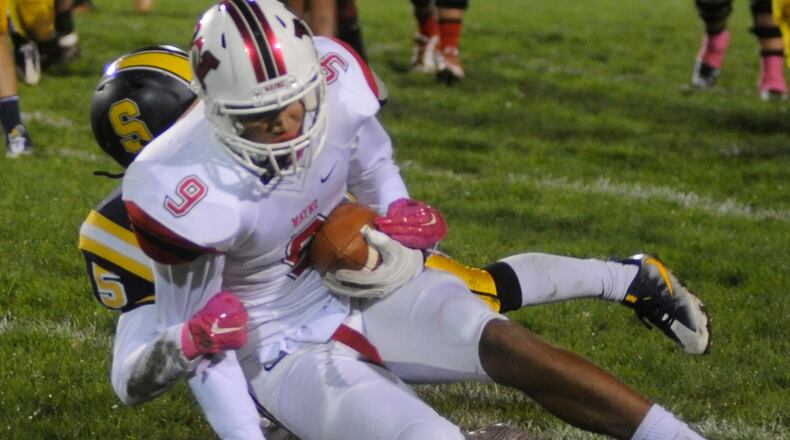 Wayne’s L’Christian “Blue” Smith makes a catch over Springfield defender DaSean Bradley. Springfield hosted Wayne in a Week 9 GWOC National East high school football game at Evans Stadium on Friday, Oct. 21, 2016. MARC PENDLETON / STAFF