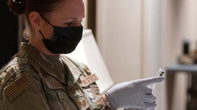 Staff Sgt. Allison Turner, 88th Healthcare Operations Squadron, fills a syringe with the COVID-19 vaccine Jan. 27 at the Wright-Patterson Club. Turner was preparing the syringes to vaccinate older beneficiaries as the 88th Medical Group expanded its vaccination program. U.S. AIR FORCE PHOTO/R.J. ORIEZ