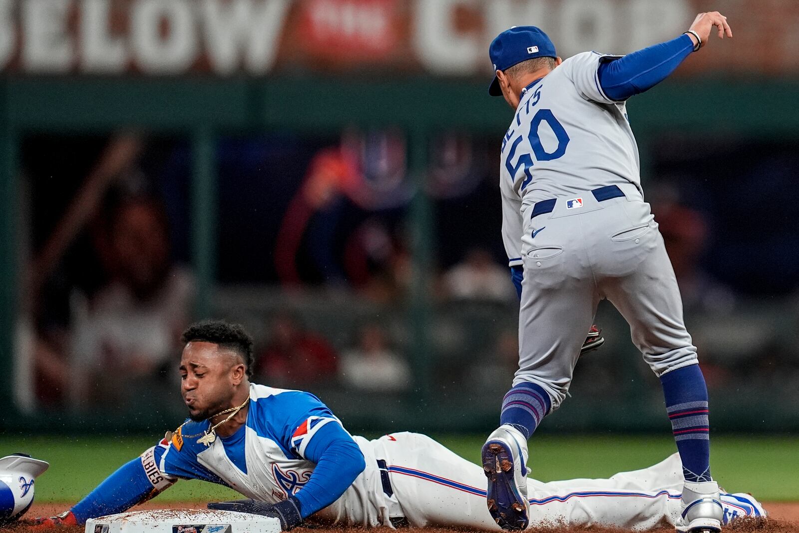 Atlanta Braves' Ozzie Albies (1) steals second base against Los Angeles Dodgers shortstop Mookie Betts (50) in the second inning of a baseball game, Saturday, May 3, 2025, in Atlanta. (AP Photo/Mike Stewart)