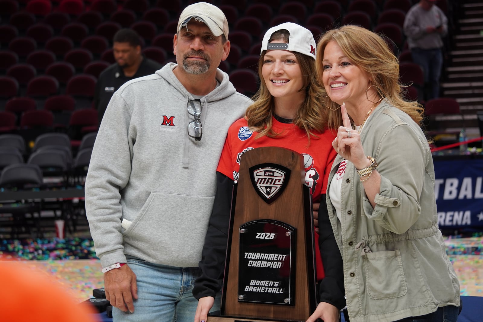 Miami assistant coach Maya Chandler poses for photos with her parents, Cary and Michelle, after the RedHawks’ won the 2026 Mid-American Conference Tournament title. CHRIS VOGT / CONTRIBUTED