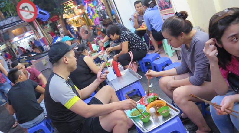 Sidewalk dining on small blue chairs is a hallmark of life in Hanoi. (Alison Bowen/Chicago Tribune/TNS)
