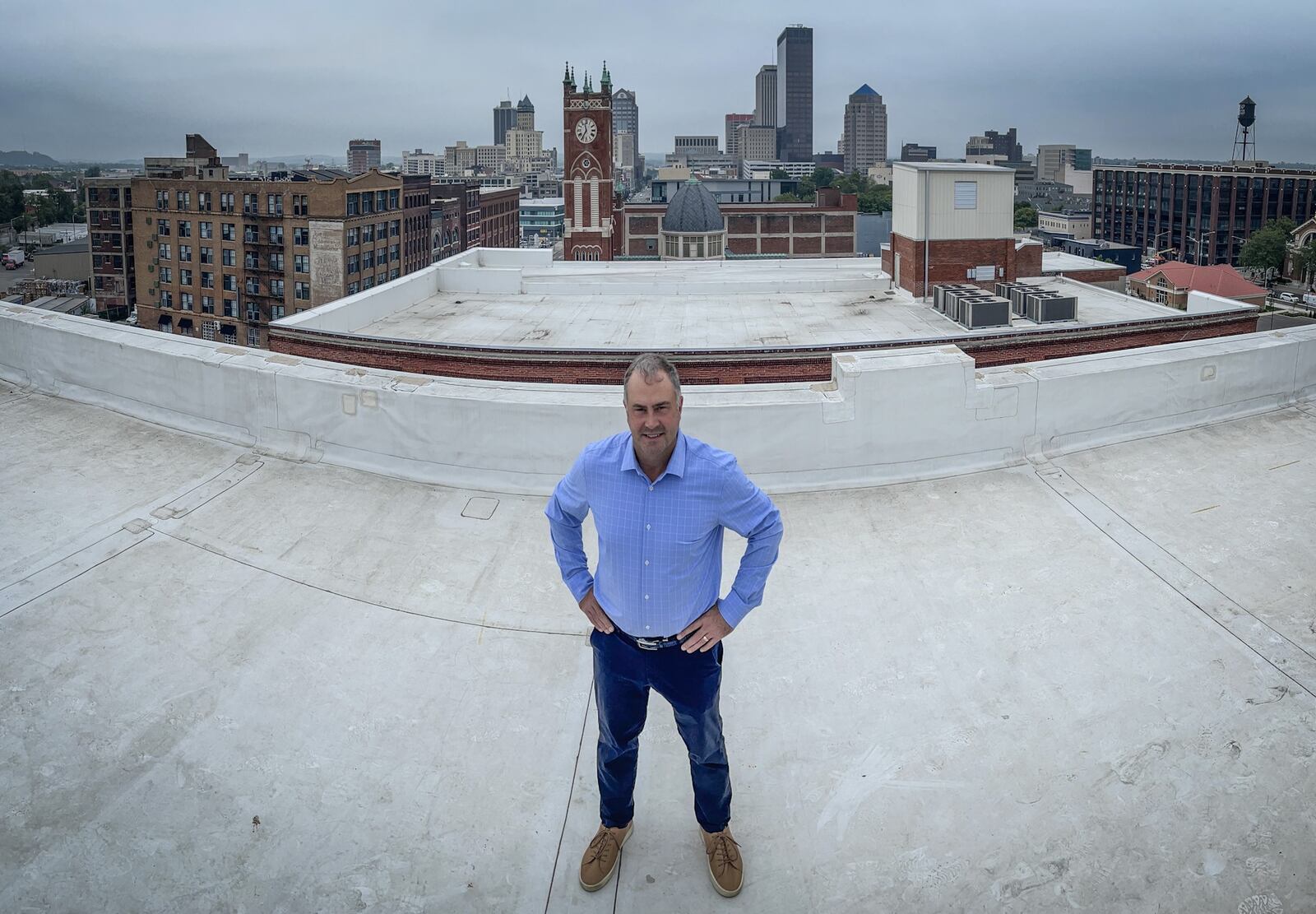 Jason Woodard, from Dayton is the founder and principal of Dayton-based Woodard Development. Woodard is photographed on the Manhattan building in Dayton, a building his company bought and rehabbed. JIM NOELKER/STAFF