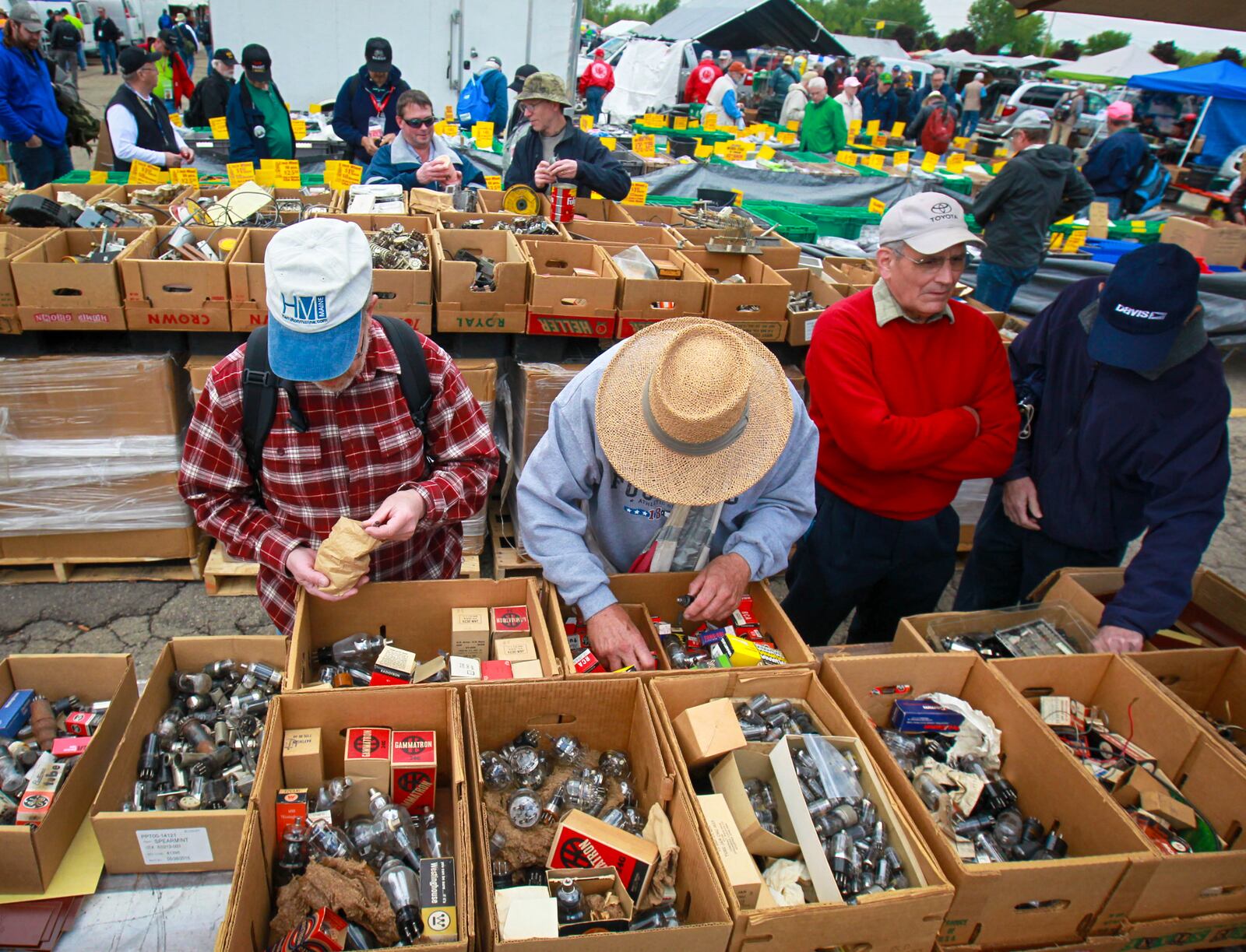 Shoppers look at thousands of parts for sale at one of the many vendors at the Dayton Hamvention at Hara Arena. With nearly 30,000 people expected to come to Trotwood this weekend to attend the convention and tapings of a popular Ohio lottery show, the city and Montgomery County could see over $6 million in revenue. JIM WITMER / STAFF