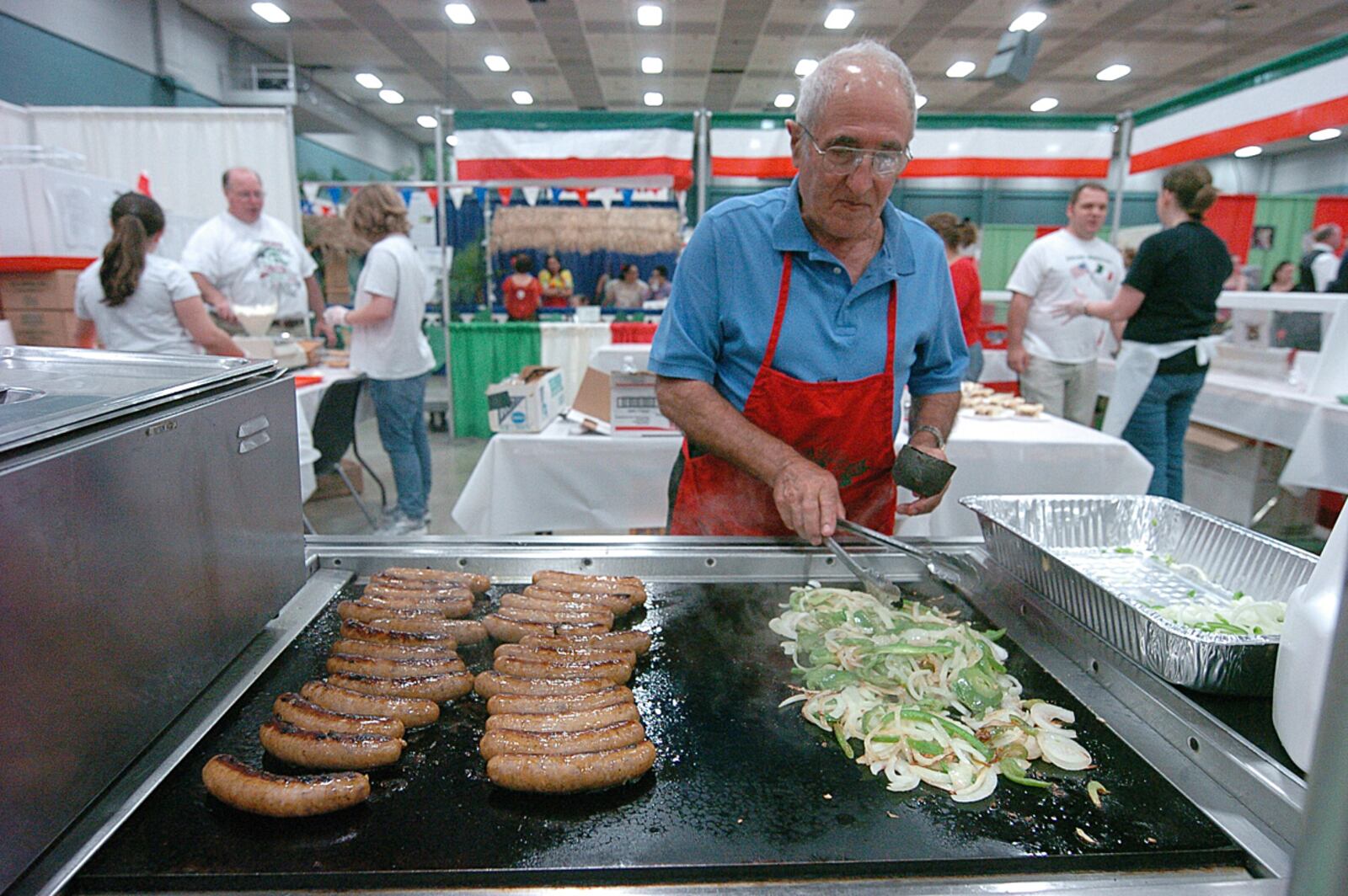 Jino Manzo preparing Italian sausage and vegetables   the 39th annual  A World A'Fair  held Saturday at the Dayton Convention Center Contributed Photo by Charles Caperton