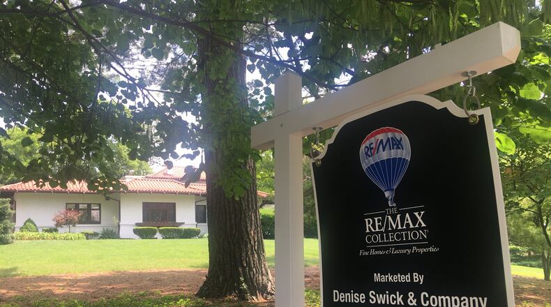 A house lined with trees is for sale on quiet, residential Ridgeway Road in Oakwood. KARA DRISCOLL/STAFF