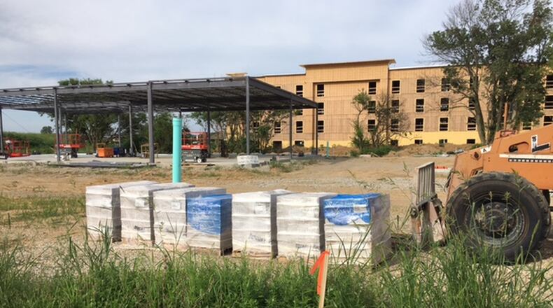 Construction continues at Progress and Hospitality drives on the Hampton Inn & Suites and two retail buildings owned by PS Dayton. Staff Photo/Richard Wilson