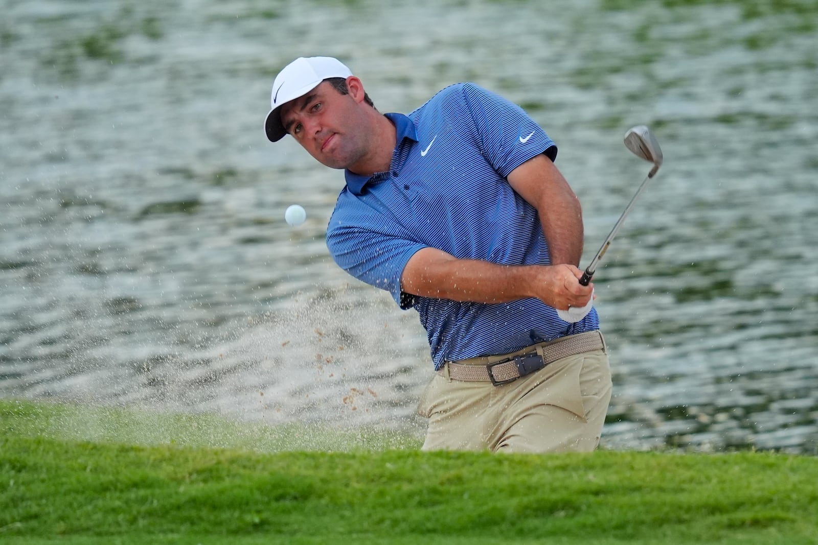 Scottie Scheffler hits out of a bunker on the 18th hole during the first round of the Charles Schwab Challenge golf tournament at Colonial Country Club in Fort Worth, Texas, Thursday, May 22, 2025. (AP Photo/LM Otero)